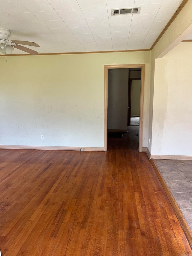 tiled empty room featuring ceiling fan