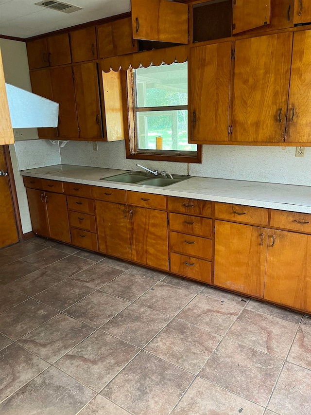 kitchen with dark tile flooring and sink