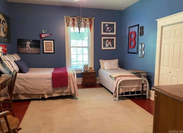 bedroom with a closet and dark hardwood / wood-style floors