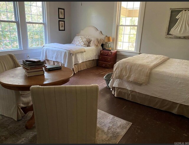 bedroom with dark hardwood / wood-style floors