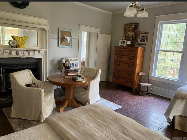 sitting room featuring a chandelier, crown molding, and dark wood-type flooring