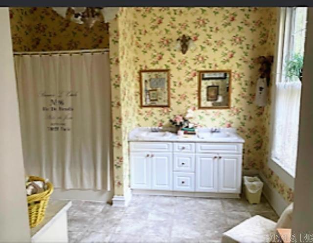 bathroom featuring tile flooring and dual vanity