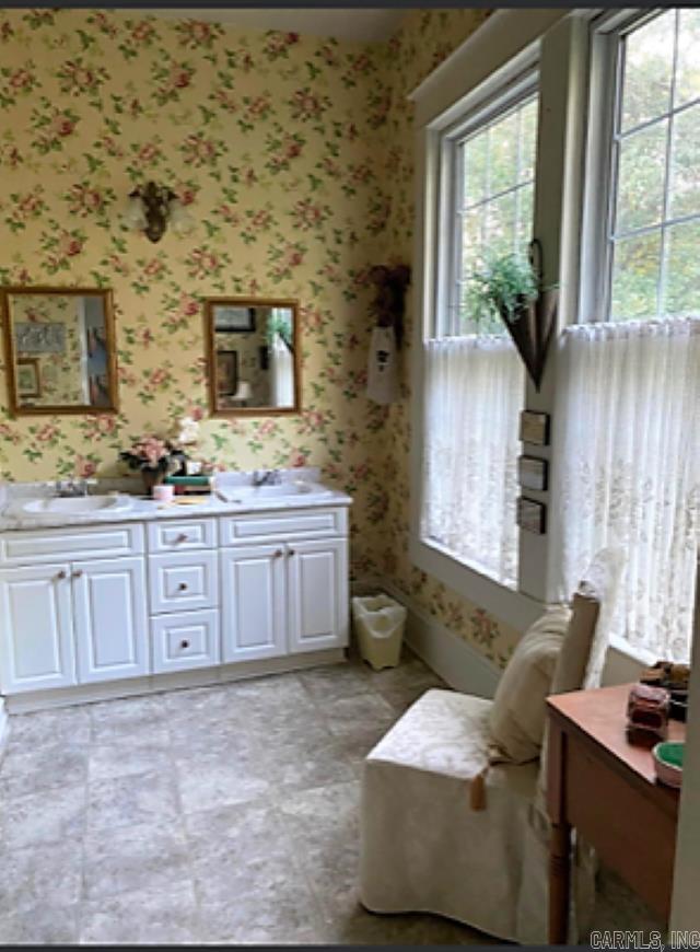 living area featuring light tile flooring and sink