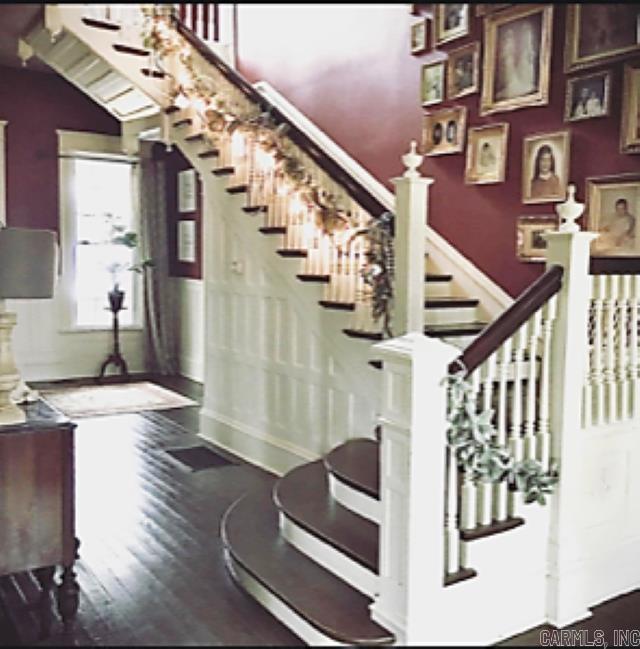 stairs with dark hardwood / wood-style floors