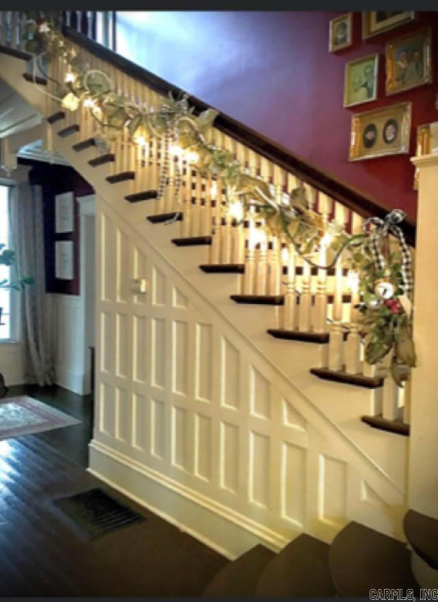 staircase with dark wood-type flooring