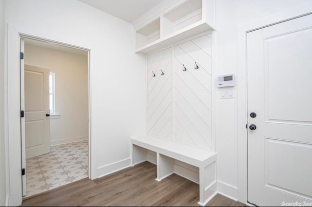 mudroom with dark tile floors