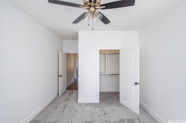 unfurnished bedroom with ceiling fan, a closet, and light carpet