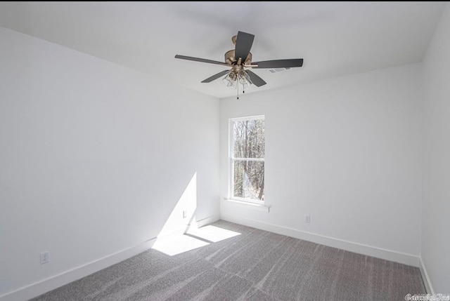 carpeted spare room featuring ceiling fan