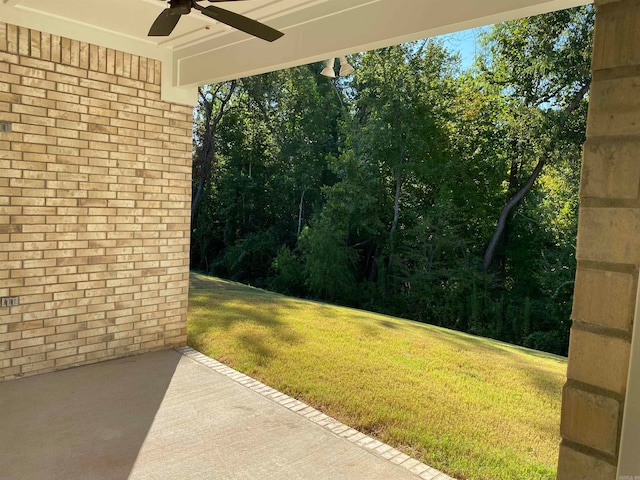 view of yard with ceiling fan and a patio area