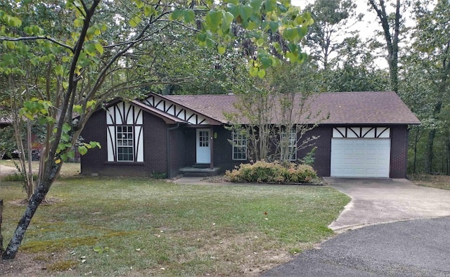 english style home featuring a front lawn and a garage