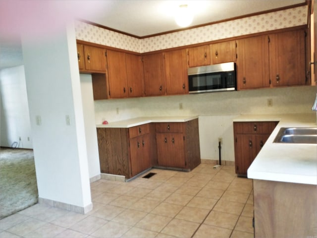 kitchen featuring sink and light tile floors