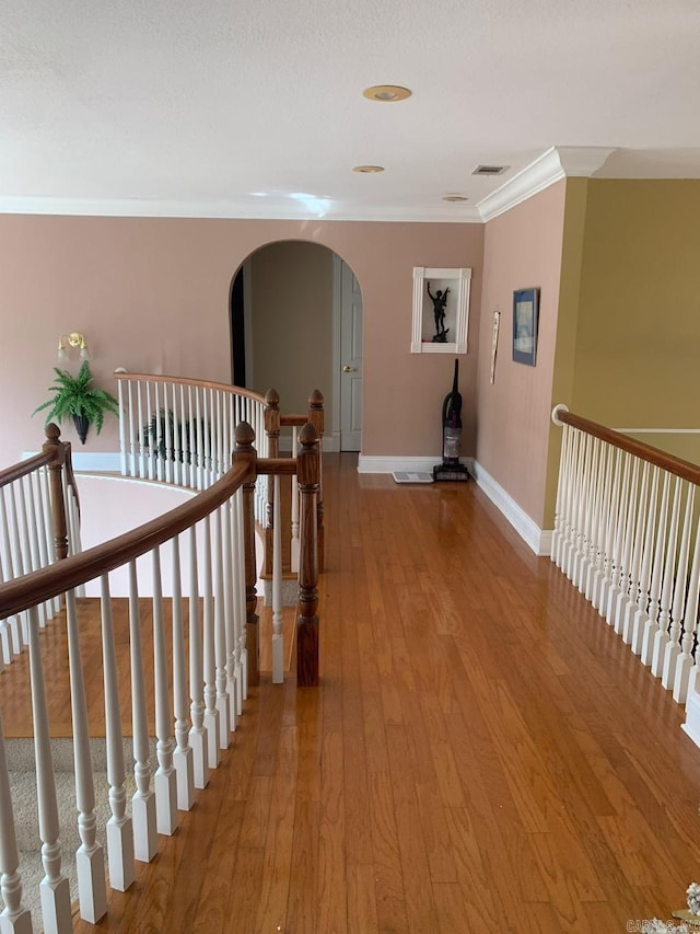 corridor featuring light hardwood / wood-style floors and ornamental molding