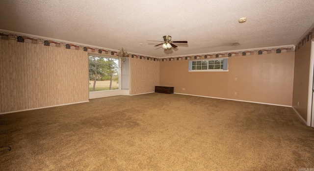 carpeted spare room featuring a textured ceiling and ceiling fan