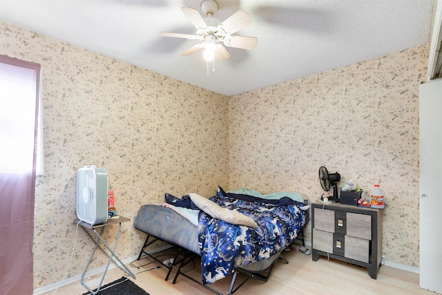 bedroom with ceiling fan and light wood-type flooring