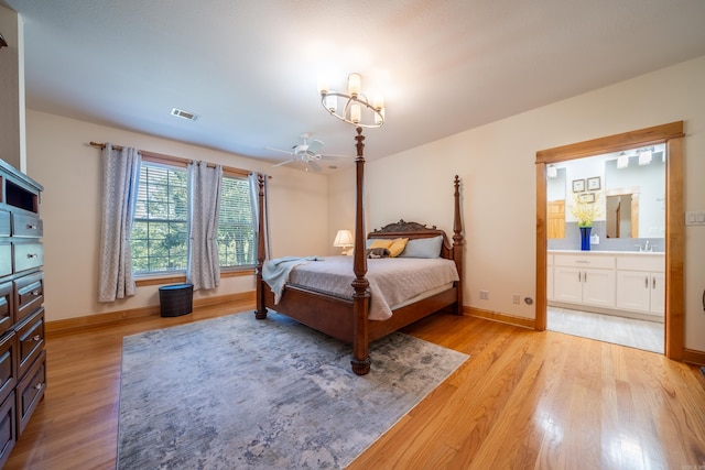 bedroom with sink, ensuite bathroom, and light hardwood / wood-style floors