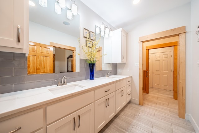 bathroom with double sink vanity, tasteful backsplash, and tile floors