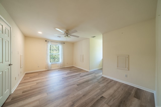 unfurnished room with ceiling fan and light hardwood / wood-style floors