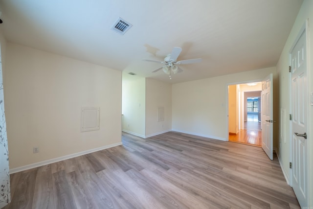 empty room with ceiling fan and light wood-type flooring