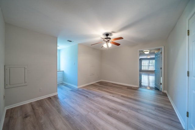 spare room featuring light hardwood / wood-style flooring and ceiling fan