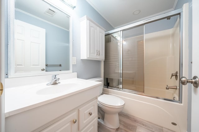 full bathroom featuring toilet, enclosed tub / shower combo, ornamental molding, wood-type flooring, and oversized vanity