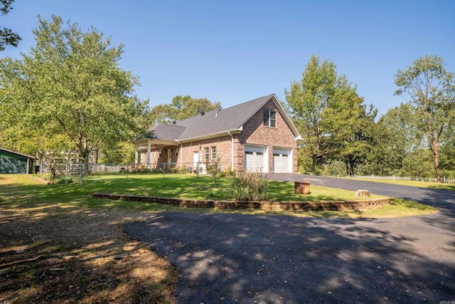 view of front of house featuring a front yard and a garage