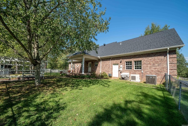 rear view of house featuring a lawn