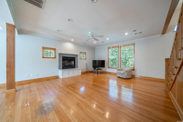 unfurnished living room with ceiling fan, ornamental molding, and light hardwood / wood-style floors