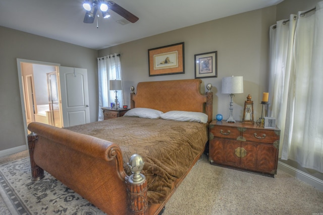 carpeted bedroom featuring ceiling fan and ensuite bath