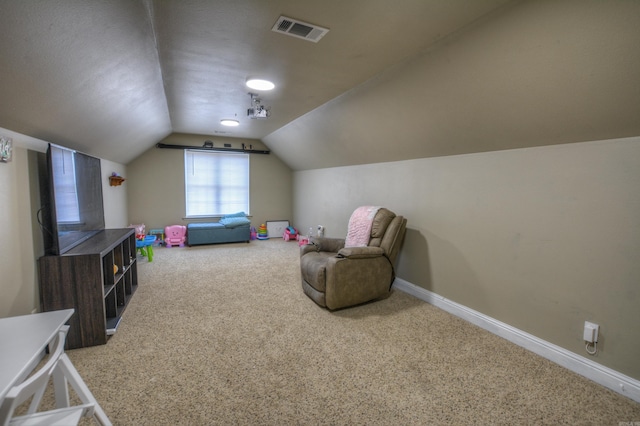 playroom with light carpet and vaulted ceiling