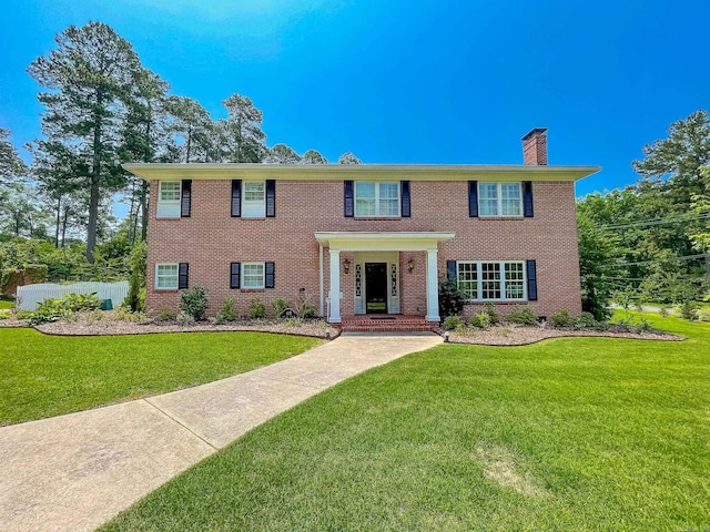 colonial inspired home with a front yard