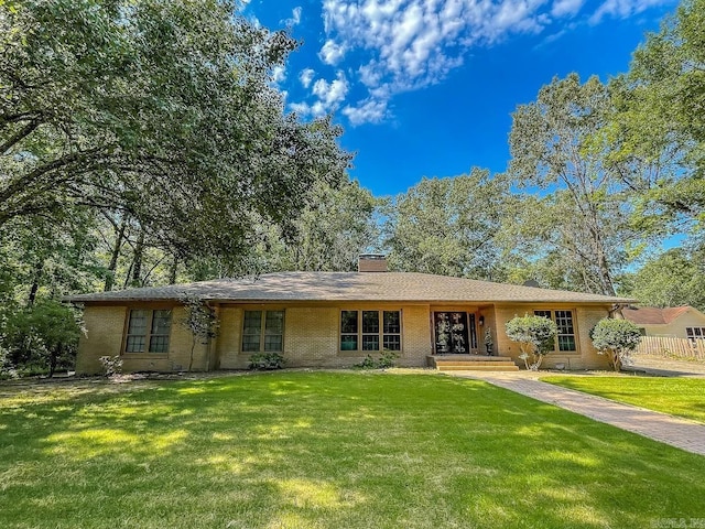 ranch-style home with a front lawn