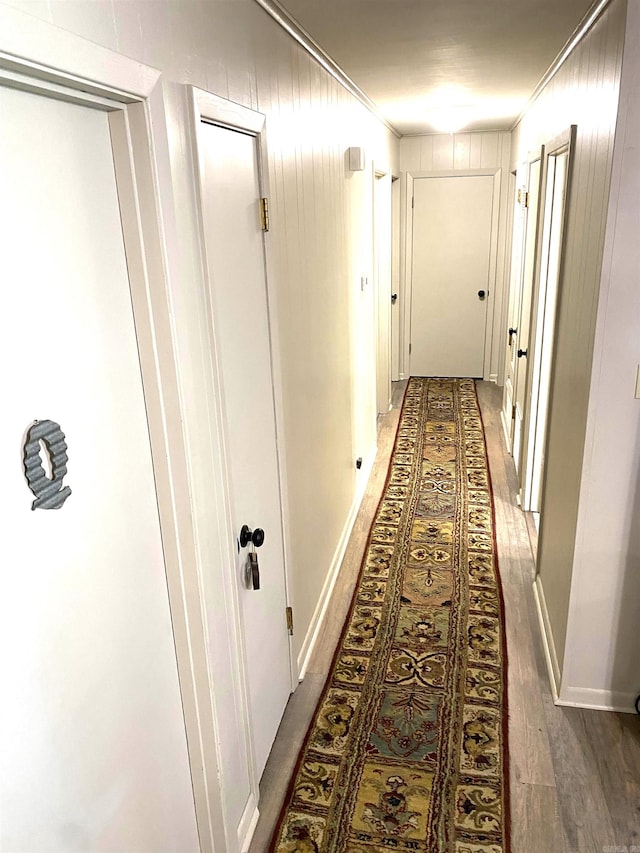 hall featuring ornamental molding and light hardwood / wood-style flooring