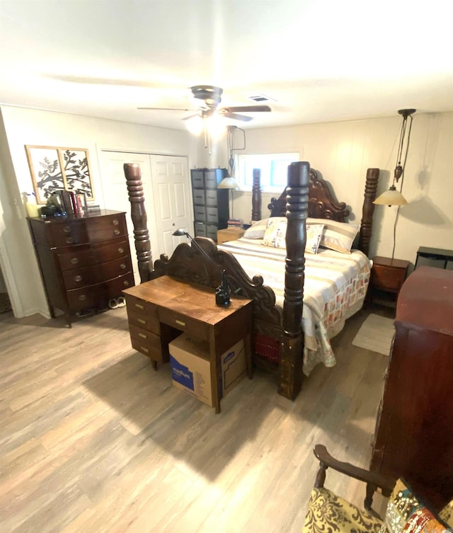 bedroom with ceiling fan, a closet, and light hardwood / wood-style flooring