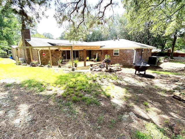 rear view of house featuring central AC unit and a patio