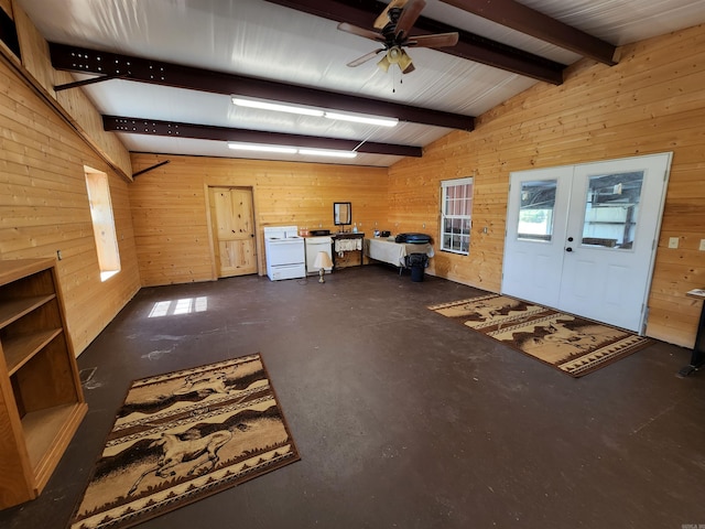 unfurnished living room with lofted ceiling with beams, french doors, wooden walls, and ceiling fan