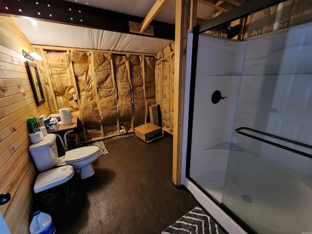 bathroom featuring toilet and an enclosed shower