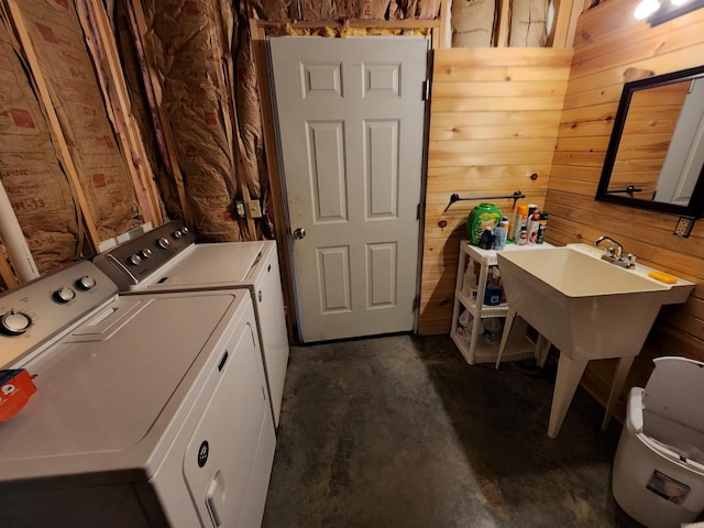 laundry room with independent washer and dryer and wooden walls