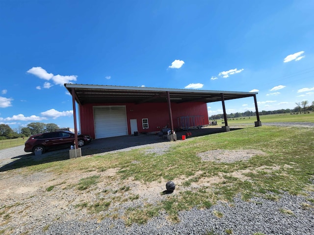 garage with a lawn and a carport