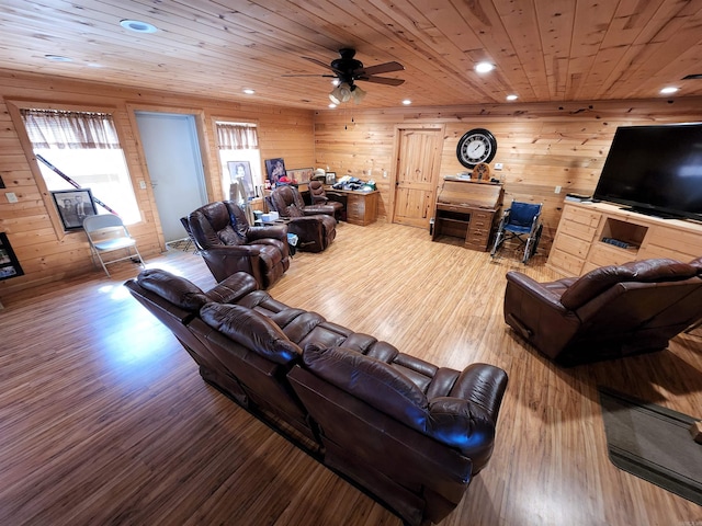 living room featuring wood walls, wooden ceiling, wood-type flooring, and ceiling fan