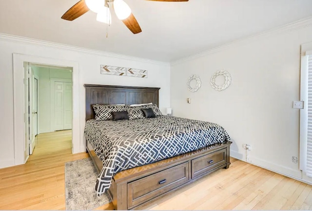 bedroom with crown molding, light hardwood / wood-style floors, and ceiling fan