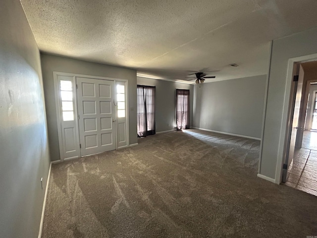 carpeted entryway featuring a textured ceiling and ceiling fan