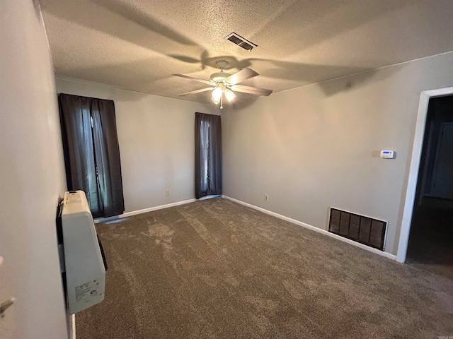 carpeted spare room with a textured ceiling and ceiling fan