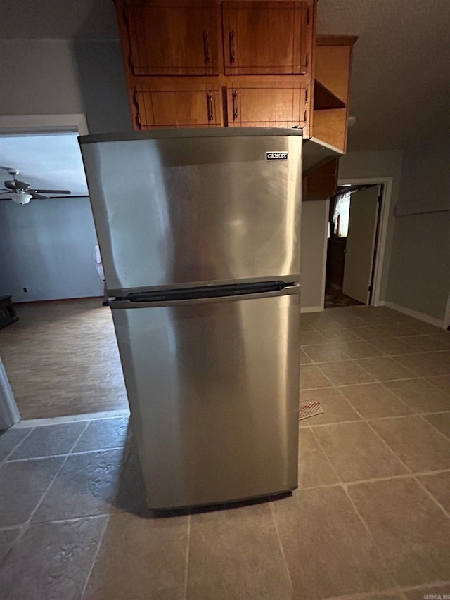 kitchen with stainless steel fridge, ceiling fan, and light tile flooring