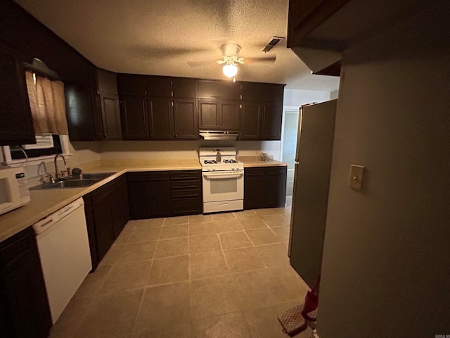 kitchen with white appliances, ceiling fan, light tile floors, sink, and dark brown cabinets