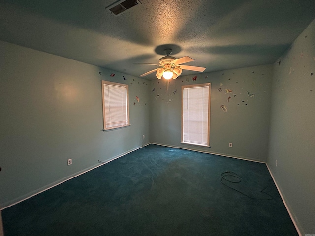 carpeted empty room featuring a textured ceiling and ceiling fan