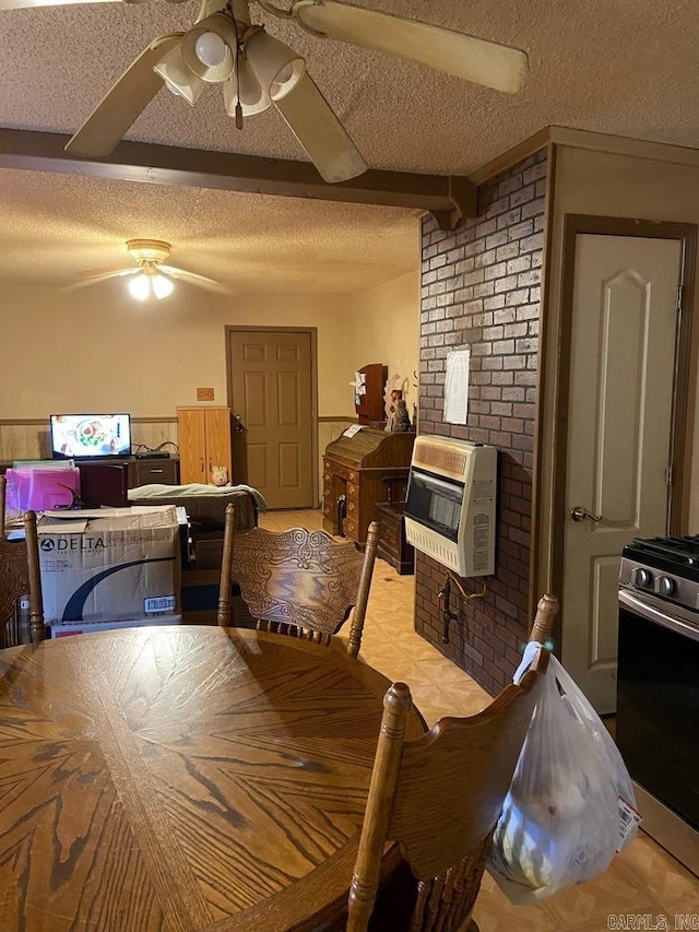 dining space with ceiling fan, a textured ceiling, and brick wall