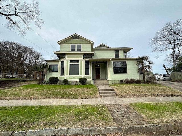 bungalow-style home with a front lawn and a porch