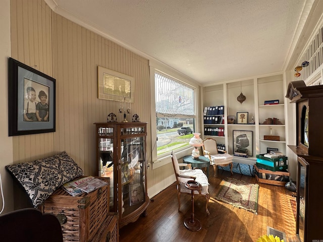 office space with built in features, a textured ceiling, dark hardwood / wood-style flooring, and ornamental molding