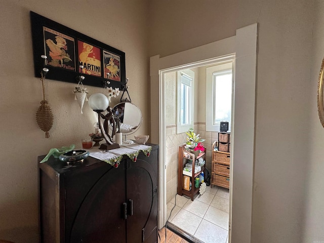 doorway to outside featuring light tile flooring