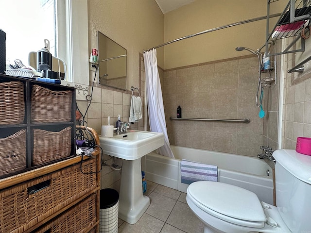 bathroom featuring shower / tub combo, tile flooring, toilet, and tile walls